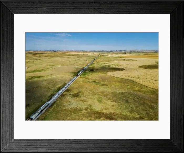 Framed Print : Aerial view of a train traveling through farmer's fields in a southern Saskatchewan prairie near Moose Jaw, Canada Framed Print : Aerial view of a train traveling through farmer's fields in a southern Saskatchewan prairie near Moose Jaw, Canada