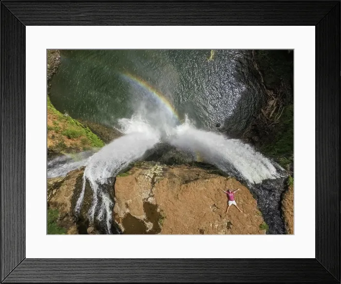 Framed Print : HAWAII - October 15 2016 : Aerial view of a man lying on the top of Wailua falls in Hawaii, USA Framed Print : HAWAII - October 15 2016 : Aerial view of a man lying on the top of Wailua falls in Hawaii, USA
