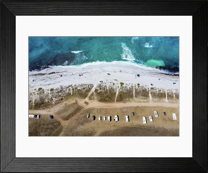 Framed Print : Aerial view of a serene beach with parked cars and clear waters Framed Print : Aerial view of a serene beach with parked cars and clear waters