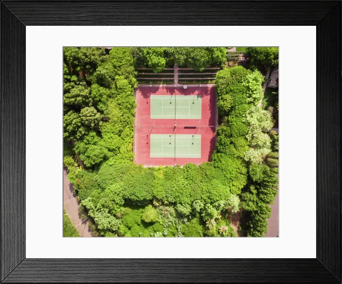Framed Print : Aerial view of tennis courts in the middle of dense vegetation in Dubai, U.A.E Framed Print : Aerial view of tennis courts in the middle of dense vegetation in Dubai, U.A.E