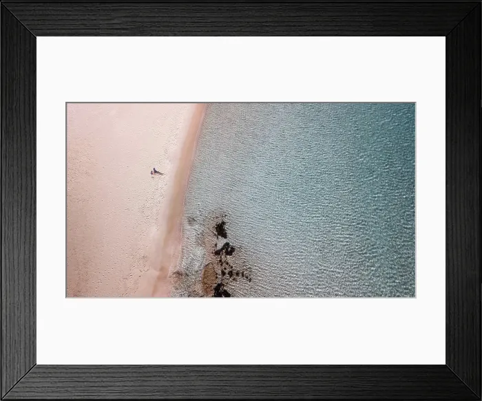 Framed Print : a woman alone on a beach with a clear blue water in Greece Framed Print : a woman alone on a beach with a clear blue water in Greece