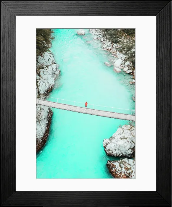 Framed Print : Aerial shot of young woman standing on bridge above whitewater river Framed Print : Aerial shot of young woman standing on bridge above whitewater river
