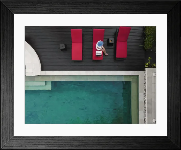Framed Print : Aerial view young woman with laptop near pool Framed Print : Aerial view young woman with laptop near pool