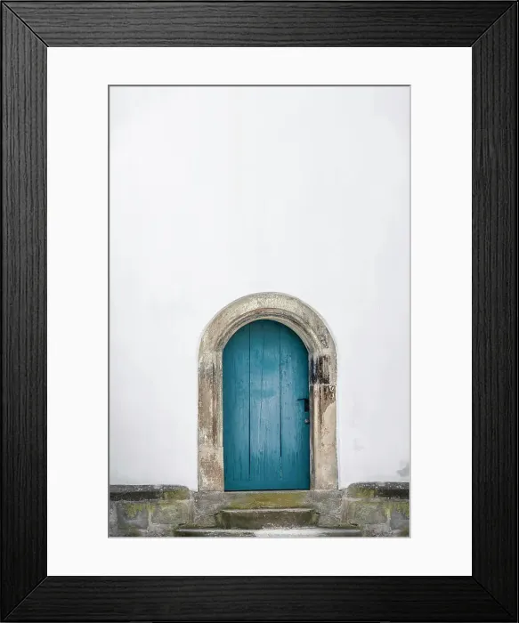Framed Print : Medieval arched door. Aged wooden door in blue color with stone stairs and white wall Framed Print : Medieval arched door. Aged wooden door in blue color with stone stairs and white wall