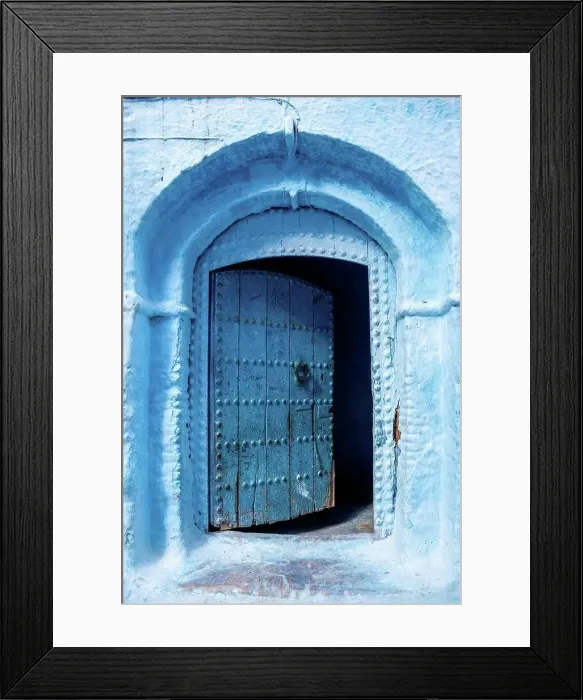 Framed Print : Vibrant blue colored wooden door in downtown Chefchaouen, Morocco Framed Print : Vibrant blue colored wooden door in downtown Chefchaouen, Morocco