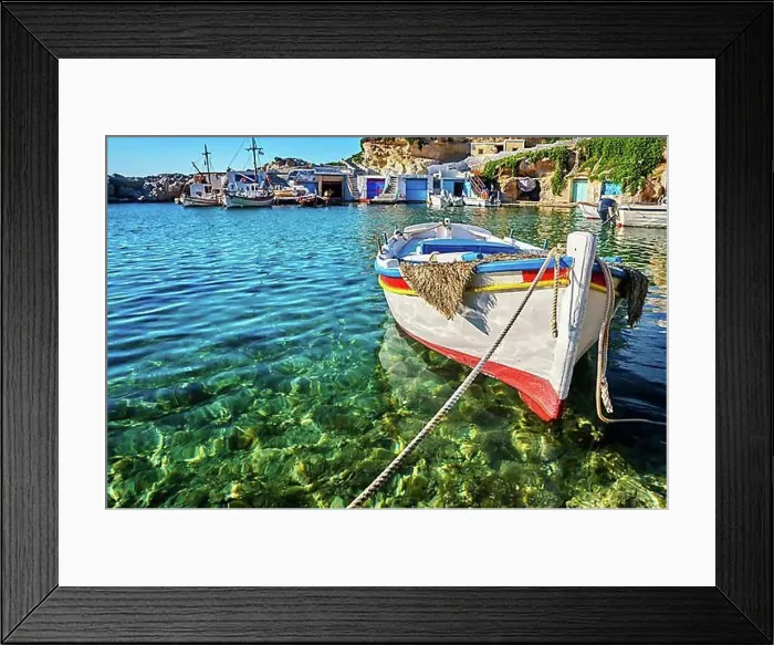 Framed Print : Colorful authentic Greek fishing boats anchored in a small village in crystal clear sea waters