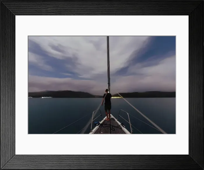 Framed Print : Indonesia, Lombok island, man on deck of a sailing boat at dusk