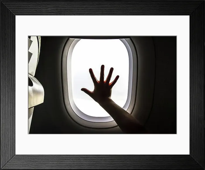 Framed Print : Aircraft window and hand of a child Framed Print : Aircraft window and hand of a child