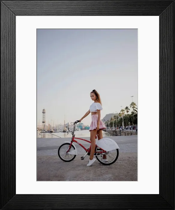 Framed Print : Fashionable young woman exploring Barcelona with a bicycle Framed Print : Fashionable young woman exploring Barcelona with a bicycle