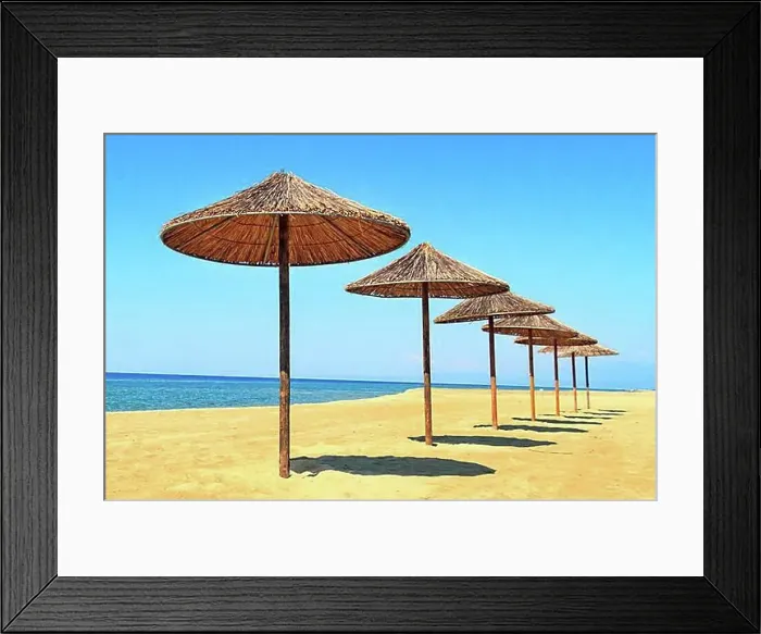 Framed Print : Row of wooden umbrellas at sandy beach, sea and blue sky vacation background, Greece, Europe Framed Print : Row of wooden umbrellas at sandy beach, sea and blue sky vacation background, Greece, Europe