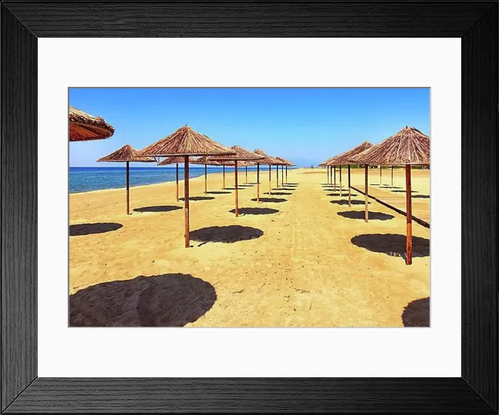 Framed Print : Row of wooden umbrellas at sandy beach, sea and blue sky vacation background, Greece, Europe Framed Print : Row of wooden umbrellas at sandy beach, sea and blue sky vacation background, Greece, Europe