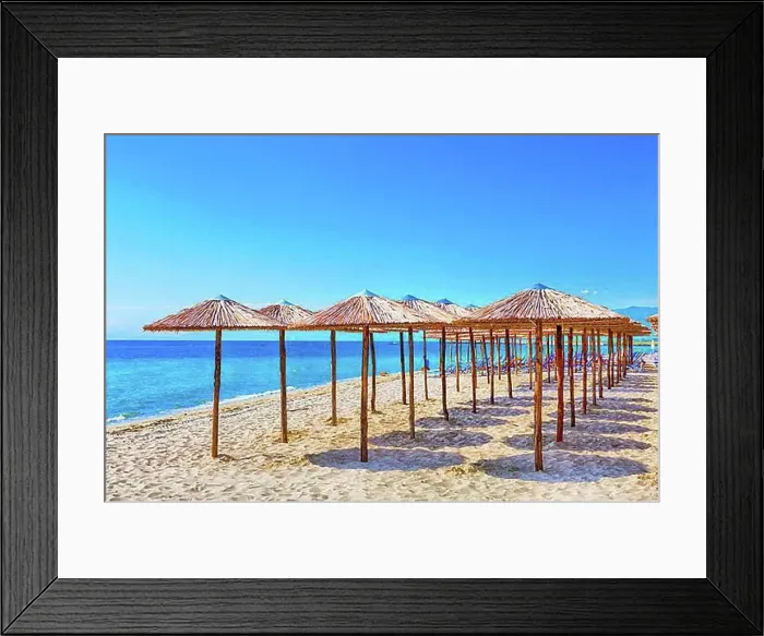 Framed Print : Row of wooden umbrellas at sandy beach, sea and blue sky vacation background, Greece, Europe Framed Print : Row of wooden umbrellas at sandy beach, sea and blue sky vacation background, Greece, Europe