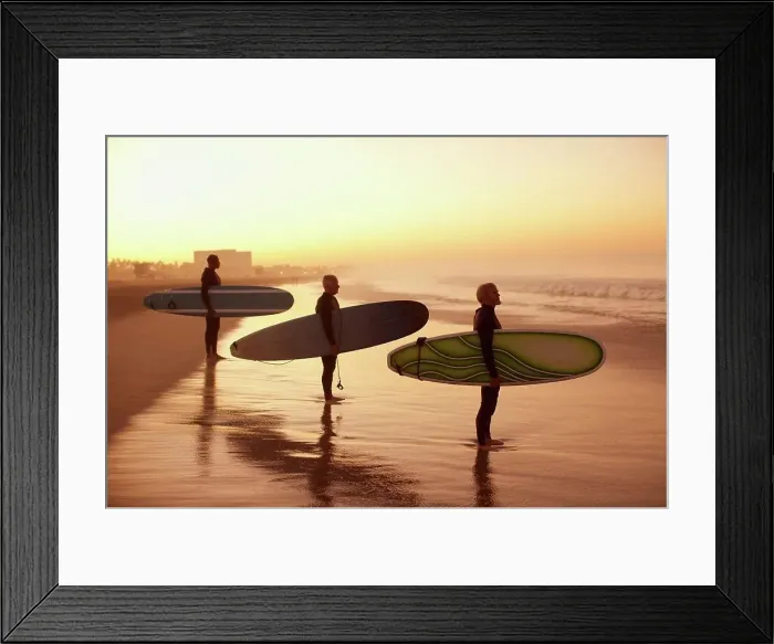 Framed Print : Los Angeles, USA, Surfers holding boards on beach