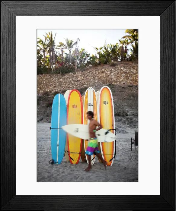 Framed Print : A surfer runs to the waves next to a stack of boards at Los Cerritos near Pescadero, Mexico Framed Print : A surfer runs to the waves next to a stack of boards at Los Cerritos near Pescadero, Mexico