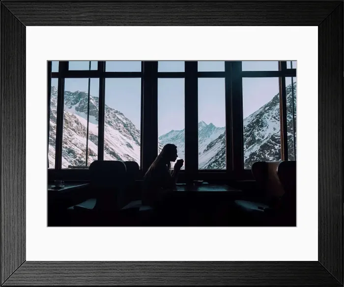 Framed Print : A woman sips hot tea overlooking the snowy mountains in Chile