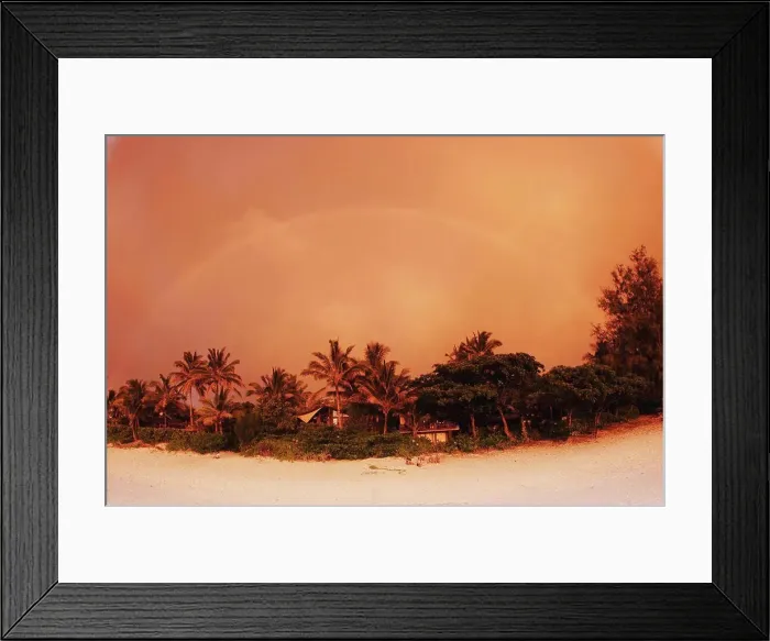 Framed Print : Hawaii, Oahu, North Shore, rainbow arching over vegetation and sandy beach at sunset, orange colored sky Framed Print : Hawaii, Oahu, North Shore, rainbow arching over vegetation and sandy beach at sunset, orange colored sky