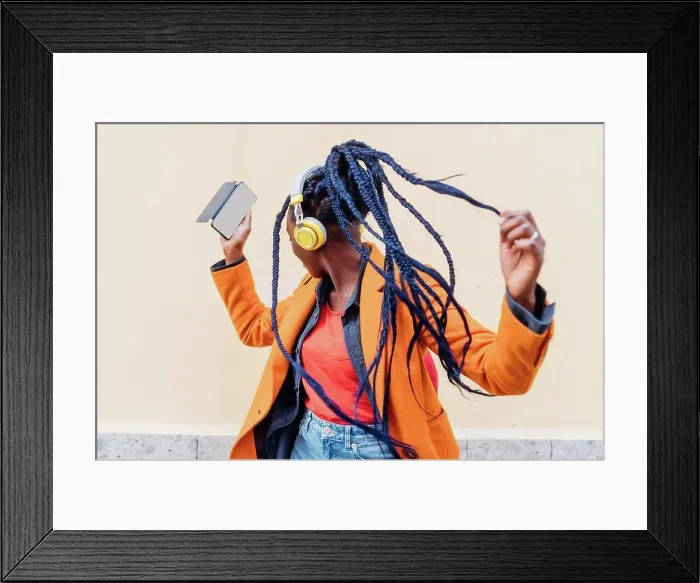 Framed Print : Italy, Milan, Woman with headphones and smart phone dancing outdoors Framed Print : Italy, Milan, Woman with headphones and smart phone dancing outdoors