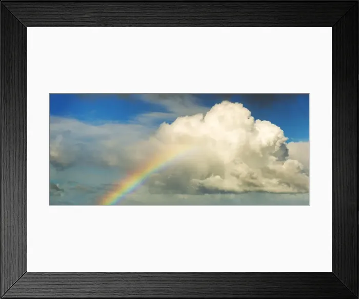 Framed Print : Spectacular rainbow in bright colors rising up to a huge white cloud with blue sky Framed Print : Spectacular rainbow in bright colors rising up to a huge white cloud with blue sky
