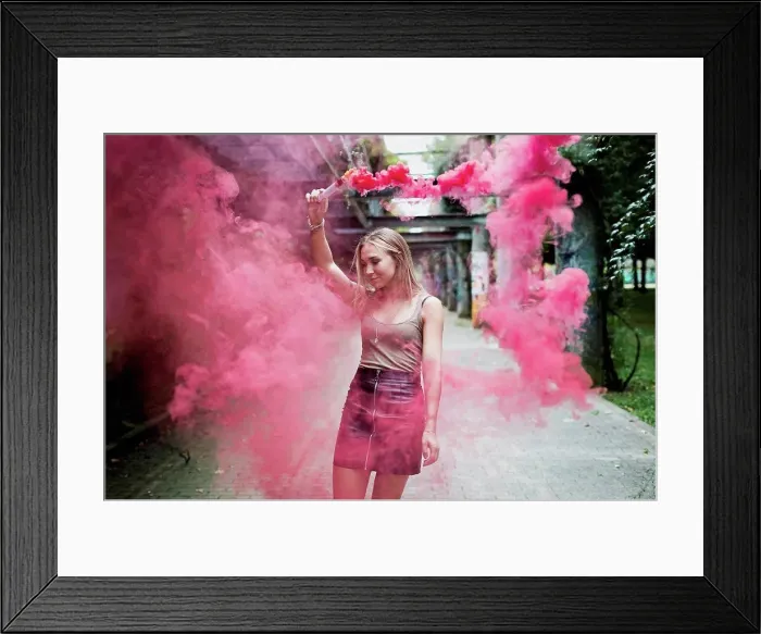 Framed Print : Young woman holding smoke torch outdoors Framed Print : Young woman holding smoke torch outdoors