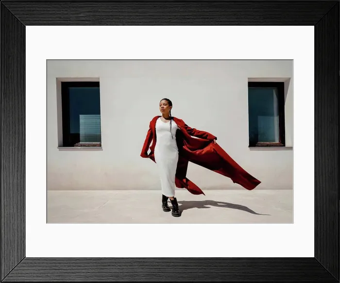 Framed Print : Beautiful woman looking away while standing in front of wall Framed Print : Beautiful woman looking away while standing in front of wall