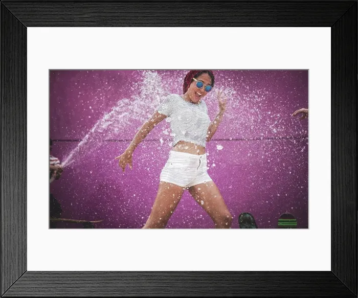Framed Print : A young woman being sprayed with water Framed Print : A young woman being sprayed with water
