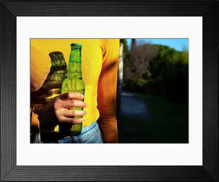 Framed Print : Woman with yellow shirt catching a green bottle of beer Framed Print : Woman with yellow shirt catching a green bottle of beer