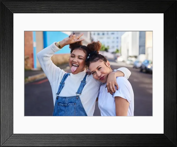 Framed Print : Were off to that white and denim party. two young woman out in the city during the day