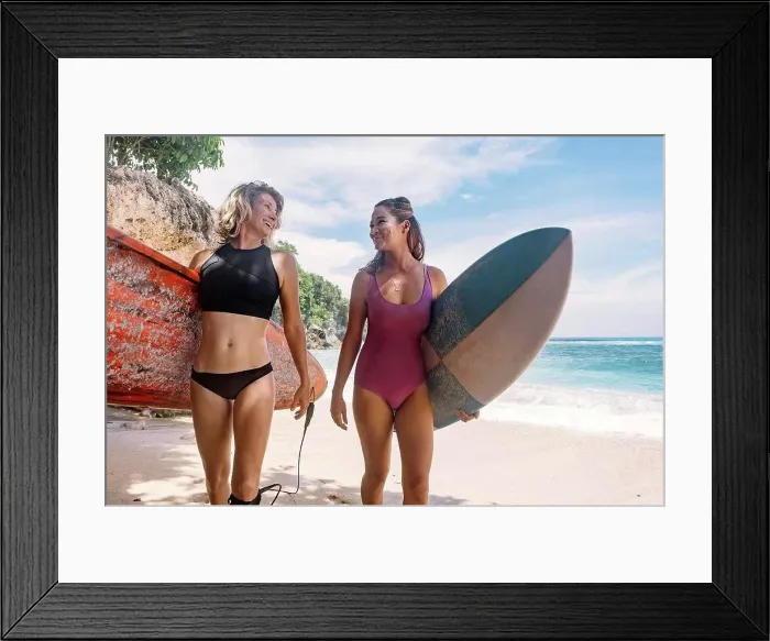 Framed Print : Smiling female surfers with surfboards walking at beach during vacation Framed Print : Smiling female surfers with surfboards walking at beach during vacation