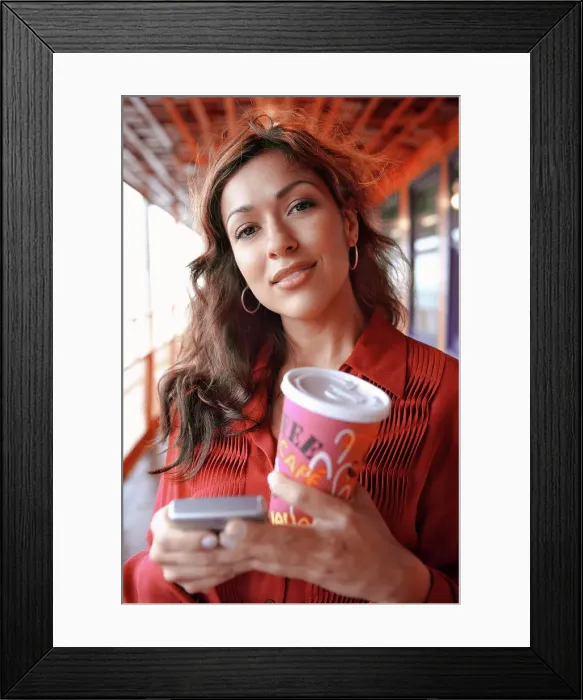 Framed Print : Hispanic businesswoman holding coffee and cell phone Framed Print : Hispanic businesswoman holding coffee and cell phone