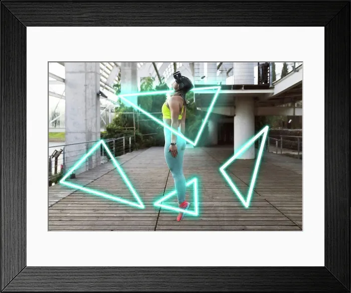 Framed Print : Young sportswoman with VR glasses jumping on footpath Framed Print : Young sportswoman with VR glasses jumping on footpath