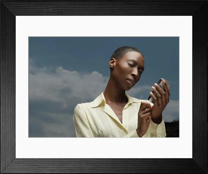 Framed Print : African businesswoman text messaging Framed Print : African businesswoman text messaging