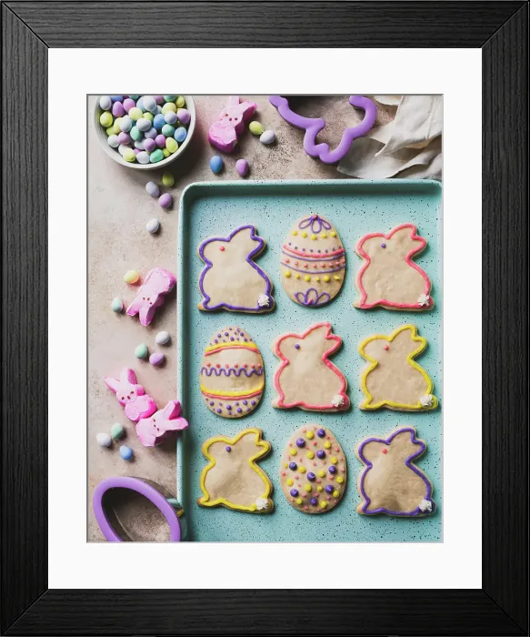Framed Print : Easter cookies shaped like eggs and bunnies on green tray from above Framed Print : Easter cookies shaped like eggs and bunnies on green tray from above