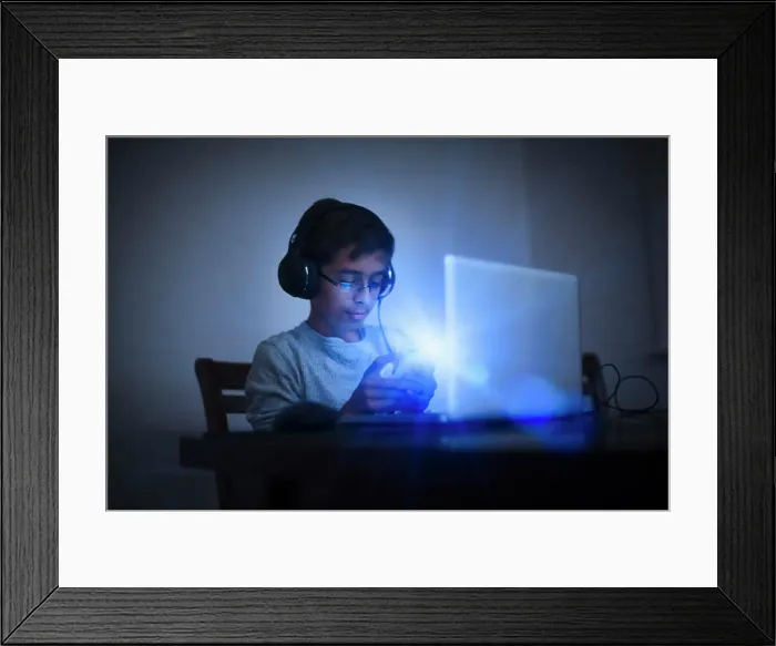 Framed Print : Mixed Race boy using cell phone and laptop Framed Print : Mixed Race boy using cell phone and laptop