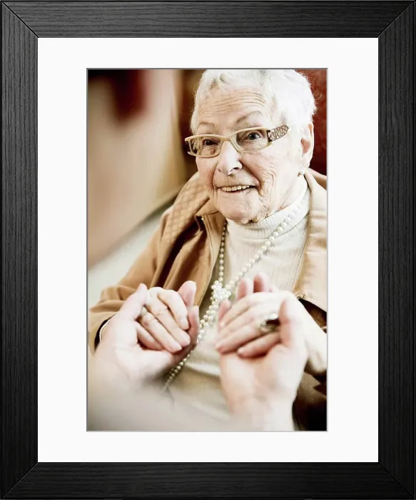 Framed Print : Portrait of senior woman with Alzheimer's disease holding hands of her adult daughter