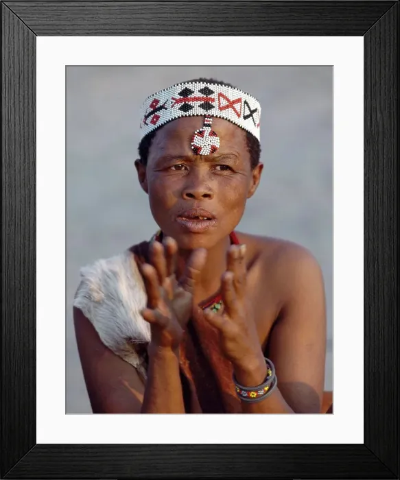 Framed Print : A Kung woman sings and claps her hands to the rhythm of her menfolk Framed Print : A Kung woman sings and claps her hands to the rhythm of her menfolk