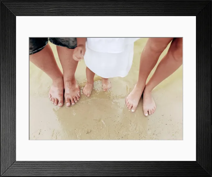 Framed Print : legs dad, mom, daughters. The family legs with little daughter on the beach Framed Print : legs dad, mom, daughters. The family legs with little daughter on the beach