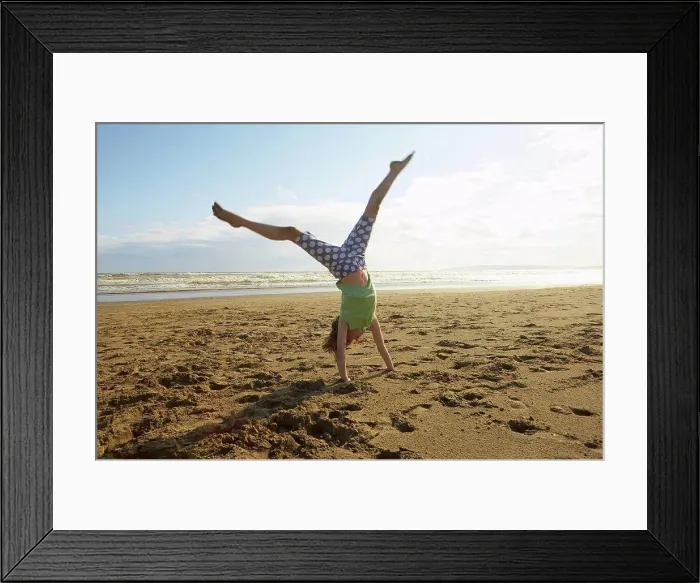 Framed Print : Girl doing handstand on beach, Camber Sands, Kent, UK Framed Print : Girl doing handstand on beach, Camber Sands, Kent, UK