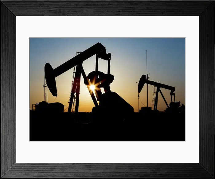 Framed Print : Silhouette of a pumpjack with sunburst at sunrise; Acme, Alberta, Canada