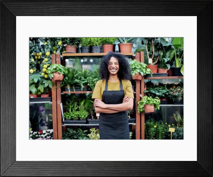 Framed Print : Portrait of cheerful owner standing at market stall
