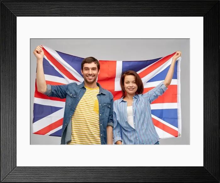Framed Print : patriotism and national concept - happy couple holding british flag over grey background Framed Print : patriotism and national concept - happy couple holding british flag over grey background