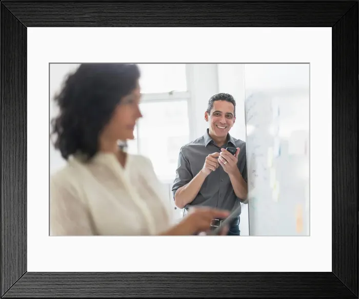 Framed Print : Man and woman working in office Framed Print : Man and woman working in office
