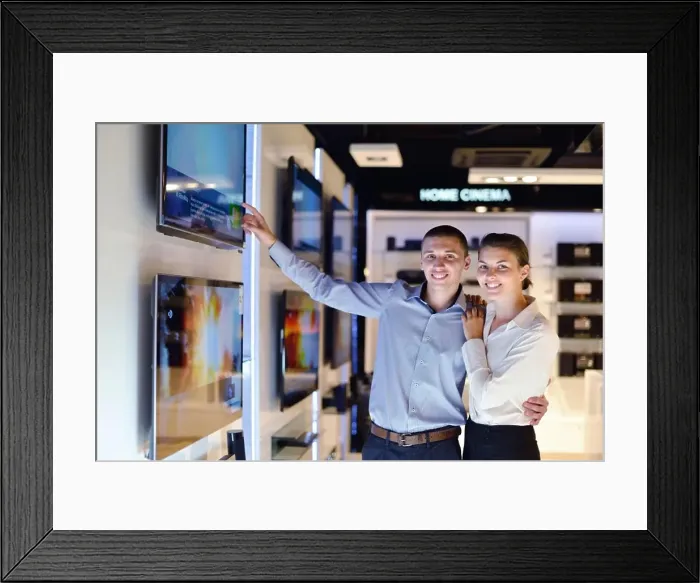 Framed Print : people in consumer electronics retail store looking at latest laptop, television and photo camera to buy Framed Print : people in consumer electronics retail store looking at latest laptop, television and photo camera to buy