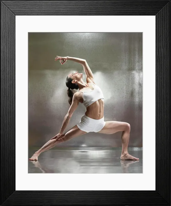 Framed Print : A caucasian female performs yoga in a studio