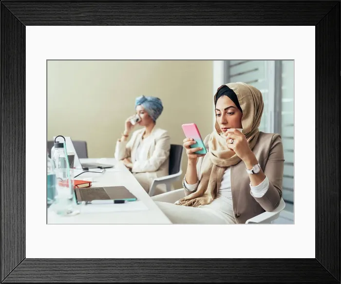 Framed Print : Businesswoman in office, using phone Framed Print : Businesswoman in office, using phone