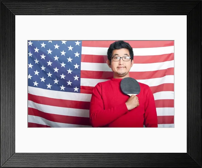 Framed Print : Proud Asian Man holding table tennis paddle against US Flag Framed Print : Proud Asian Man holding table tennis paddle against US Flag