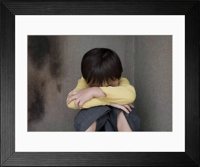 Framed Print : Boy crying in a corner