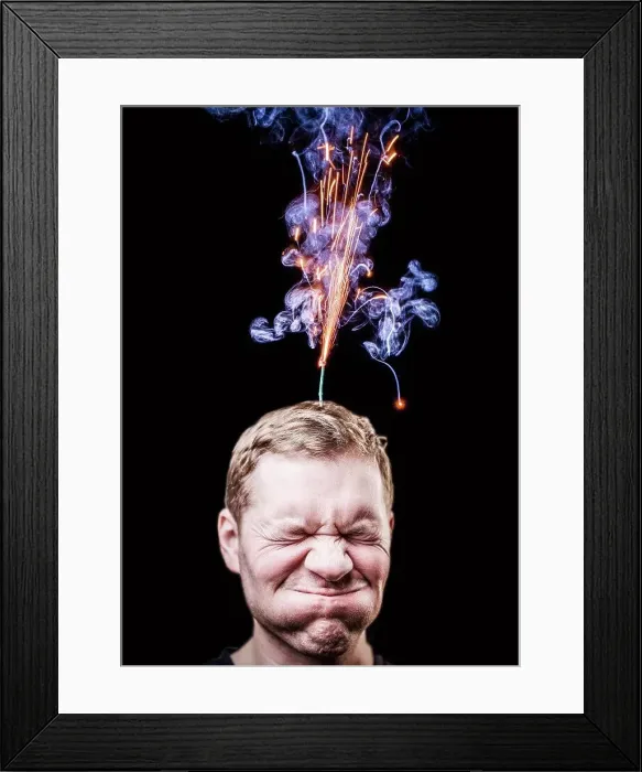 Framed Print : Fireworks emitting over mans head