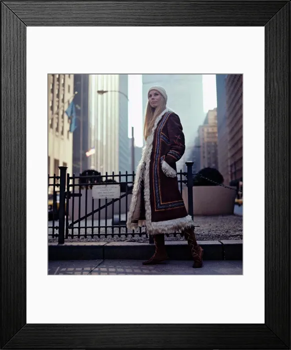 Framed Print : 1970s lifestyle and fashion. A young woman wearing a typical 1970s coat