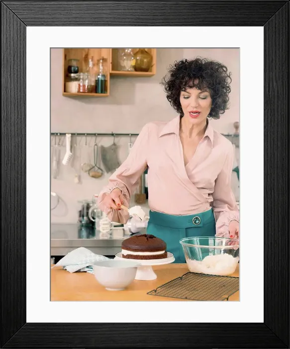 Framed Print : Woman decorating chocolate cake with dairy cream Framed Print : Woman decorating chocolate cake with dairy cream