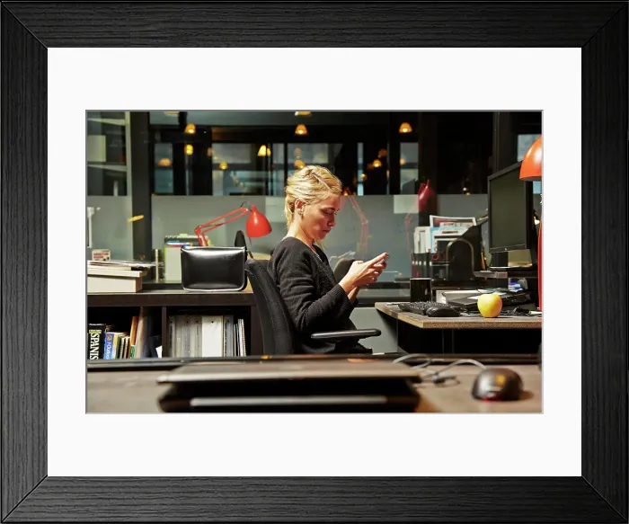 Framed Print : Focused professional working late in a modern office